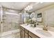 Elegant main bathroom with dual sinks, marble countertops, and a glass-enclosed shower with luxurious finishes at 8035 Downy Oak Ln, Charlotte, NC 28269