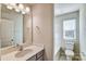 Bright bathroom with a single sink vanity and a combined shower and bathtub at 8039 Downy Oak Ln, Charlotte, NC 28269