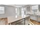 Modern kitchen island with stainless steel sink, faucet and gray cabinetry at 8039 Downy Oak Ln, Charlotte, NC 28269