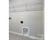 Convenient laundry area with white trim, tile floors, and practical shelving for efficient storage at 8039 Downy Oak Ln, Charlotte, NC 28269