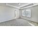 Bright main bedroom features a tray ceiling, carpet, and ensuite bathroom at 8039 Downy Oak Ln, Charlotte, NC 28269