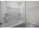 Pristine bathroom features a shower-tub combination with built-in shelving, and toilet at 845 Regulus Ct, York, SC 29745