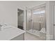 Bright bathroom featuring a walk-in shower, a window, and vanity with lots of counter space at 845 Regulus Ct, York, SC 29745