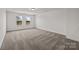 Spacious bedroom featuring neutral carpet, light-colored walls, and natural light from two windows at 845 Regulus Ct, York, SC 29745