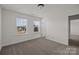 Spacious bedroom with two bright windows and plush carpet, next to the hallway and other rooms at 845 Regulus Ct, York, SC 29745