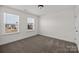 This bedroom has two windows letting in natural light, with wall-to-wall carpeting and neutral paint at 845 Regulus Ct, York, SC 29745