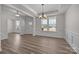 Bright dining room with a modern chandelier, wainscoting, and hardwood floors at 845 Regulus Ct, York, SC 29745