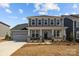 Charming two-story home with a welcoming front porch and gray siding under a blue sky at 845 Regulus Ct, York, SC 29745