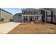 Beautiful two-story home with stone accents, a welcoming porch, and an attached two-car garage at 845 Regulus Ct, York, SC 29745