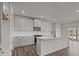 Modern kitchen features white cabinets, stainless appliances, and center island with sink at 845 Regulus Ct, York, SC 29745