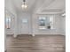 Bright living room featuring hardwood floors, large windows, and elegant trim work at 845 Regulus Ct, York, SC 29745