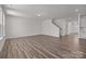 Open-concept living area with wood floors, neutral paint, and access to the staircase at 845 Regulus Ct, York, SC 29745