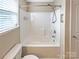 Bathroom with a tub-shower combination and a convenient shower head with window view at 8804 Artesa Mill Ln, Charlotte, NC 28214