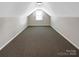 Finished bonus room with neutral carpet and plenty of natural light from a window at 8804 Artesa Mill Ln, Charlotte, NC 28214
