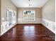 Bright dining room with hardwood floors, neutral colors, and french doors leading to the patio at 8804 Artesa Mill Ln, Charlotte, NC 28214