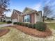 Charming brick home with a two-car garage, manicured landscaping, and a welcoming entrance at 8804 Artesa Mill Ln, Charlotte, NC 28214