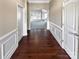 Inviting foyer with dark wood floors and decorative molding leads to a spacious living area at 8804 Artesa Mill Ln, Charlotte, NC 28214
