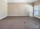 Spacious living room offering neutral carpet and ample natural light at 8804 Artesa Mill Ln, Charlotte, NC 28214
