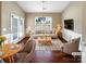 Bright living room features hardwood floors, neutral colors, and large windows with plenty of natural light at 8804 Artesa Mill Ln, Charlotte, NC 28214