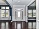 Bright foyer featuring hardwood floors, wainscoting, transom window, and doorway to the living spaces at 10094 Dressage Ln, Midland, NC 28107