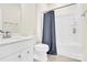Bright bathroom with a combination bathtub and shower, white vanity with a sink, toilet, and tiled floors at 112 August Ln, Matthews, NC 28104