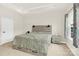 Neutral bedroom with a tray ceiling, carpet floors, sleek, modern furnishings, and a bedside table with a table lamp at 112 August Ln, Matthews, NC 28104