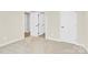 An empty bedroom with neutral walls, plush carpeting, white trim, and multiple interior doors at 112 August Ln, Matthews, NC 28104