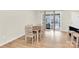 Dining room features a light wood table with chairs, hardwood floors, and lots of natural light from the sliding door at 112 August Ln, Matthews, NC 28104
