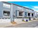 Townhome showcasing a well-maintained exterior with gray siding, balconies, and garages at 112 August Ln, Matthews, NC 28104