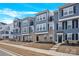 Charming townhome showcasing a well-maintained exterior with blue siding and brick accents at 112 August Ln, Matthews, NC 28104
