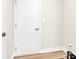 Hallway with white doors and laminate flooring at 112 August Ln, Matthews, NC 28104