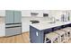 This modern kitchen features an island with bar seating, stainless steel appliances, and white cabinetry at 112 August Ln, Matthews, NC 28104
