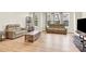 Spacious living room features hardwood floors, neutral walls, two sofas, a coffee table, and large bright windows at 112 August Ln, Matthews, NC 28104