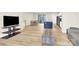 Open concept living space with an eat-in kitchen and dining area features hardwood floors, neutral walls, and lots of light at 112 August Ln, Matthews, NC 28104