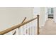 Staircase with wood and white railings with landing and hallway at 112 August Ln, Matthews, NC 28104