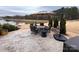 Relaxing backyard patio with outdoor dining area, an umbrella, and views of the pond at 12453 Belmont Mansion Dr, Charlotte, NC 28273