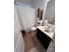 Bright bathroom features a modern vanity, framed mirror, and shower with curtain at 12453 Belmont Mansion Dr, Charlotte, NC 28273