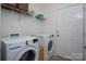 A clean and functional laundry room with modern washer, dryer, shelving, and ample space at 12453 Belmont Mansion Dr, Charlotte, NC 28273