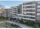 Attractive exterior view of condominium building with manicured landscaping and American flag at 1300 Reece Rd # 201, Charlotte, NC 28209