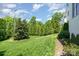 Well-manicured backyard with a lush lawn, mature trees, and thoughtful landscaping at 1328 S Kings Dr, Charlotte, NC 28207