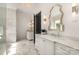 Bright bathroom with marble floors and walls, dual vanities, decorative mirrors and modern lighting at 1328 S Kings Dr, Charlotte, NC 28207