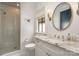 Bright bathroom features a glass walk-in shower, marble countertop, and decorative mirror at 1328 S Kings Dr, Charlotte, NC 28207