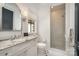 Bright bathroom with marble vanity, updated fixtures, and tiled shower with glass door at 1328 S Kings Dr, Charlotte, NC 28207