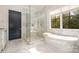 Luxurious bathroom with marble floors, free-standing tub and walk-in shower at 1328 S Kings Dr, Charlotte, NC 28207