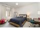Bright bedroom with a queen-sized bed, modern decor, plush carpet, and large windows at 1328 S Kings Dr, Charlotte, NC 28207