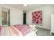 Comfortable bedroom with floral decoration, a bed with pink accents and access to the ensuite bath at 1328 S Kings Dr, Charlotte, NC 28207