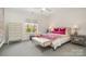 Bright bedroom with plush carpet, a queen-sized bed, and ample natural light from the large windows at 1328 S Kings Dr, Charlotte, NC 28207