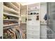 Bright closet with custom shelving and hanging storage for clothes, shoes, and accessories at 1328 S Kings Dr, Charlotte, NC 28207