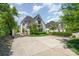 Elegant home with a landscaped front yard, charming architectural details, and a long driveway at 1328 S Kings Dr, Charlotte, NC 28207