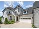 Beautiful traditional home featuring a large garage, manicured landscaping, and a modern architectural design at 1328 S Kings Dr, Charlotte, NC 28207